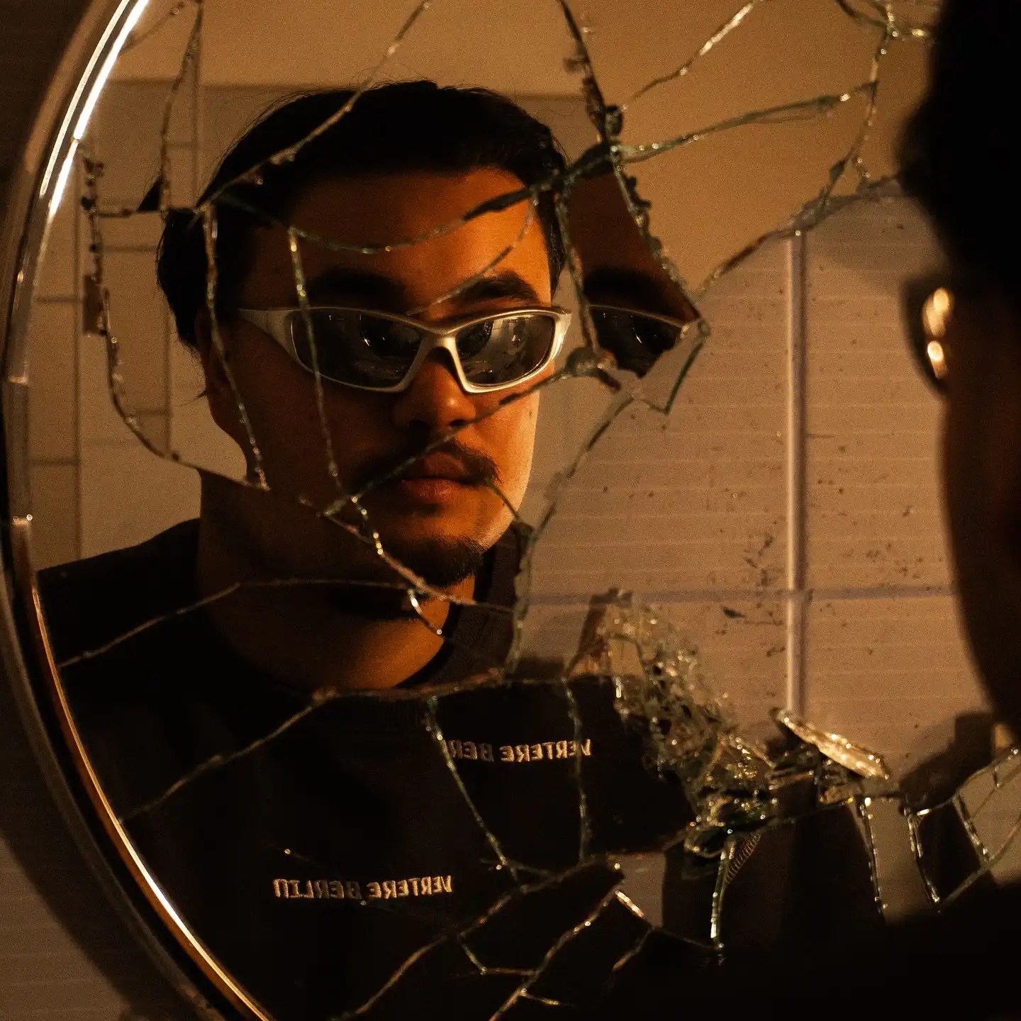 Kevin Lenhard reflected in a cracked mirror